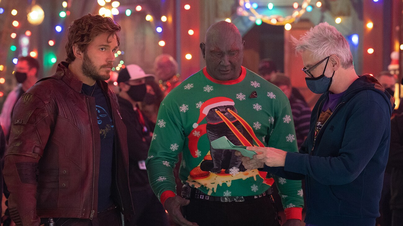 (L-R): Chris Pratt as Peter Quill/Star-Lord, Dave Bautista as Drax, and Director/Writer James Gunn behind the scenes of Marvel Studios' THE GUARDIANS OF THE GALAXY: HOLIDAY SPECIAL. Photo by Jessica Miglio. © 2022 MARVEL.