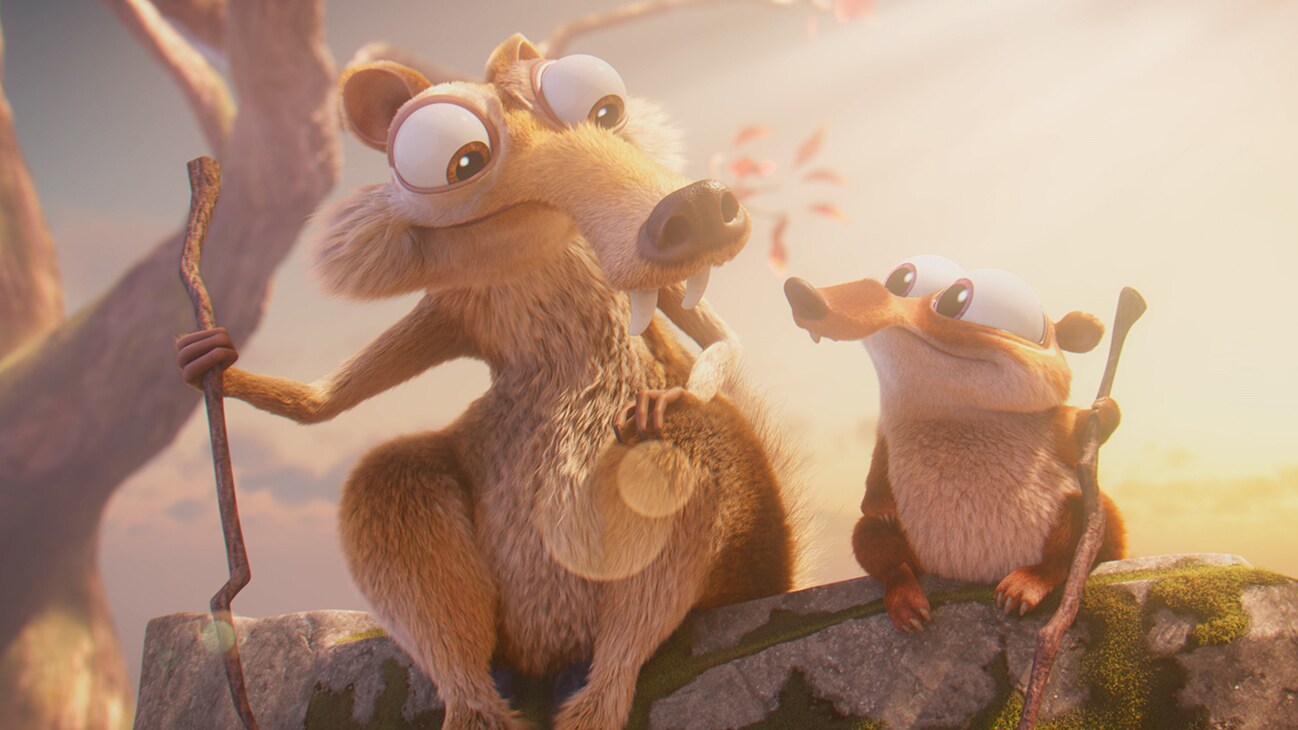 Scrat and Baby Scrat sit together on a rock.