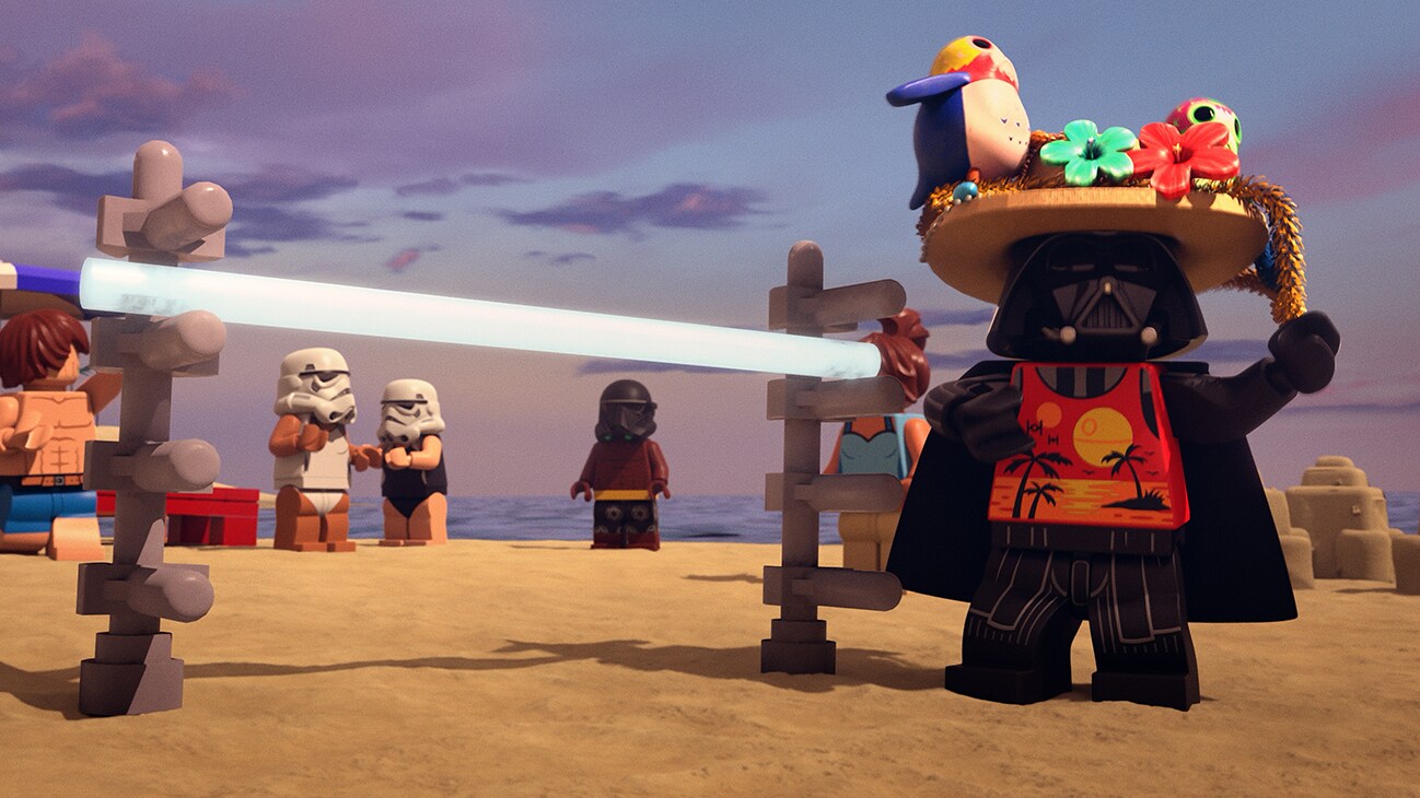Darth Vader, wearing a hat with porgs on top, is on a beach beside a limbo stick from the Disney+ Original special, "LEGO Star Wars Summer Vacation".