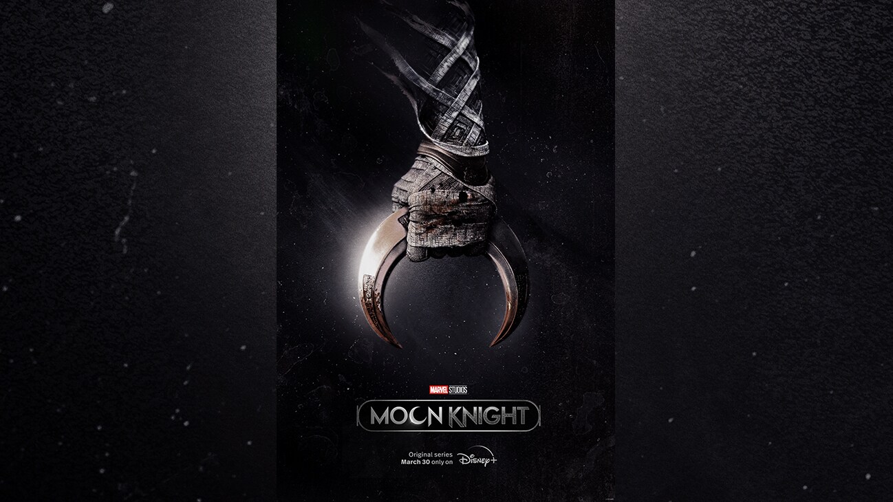 Image of a gloved hand clutching a crescent moon from the Marvel Studios series "Moon Knight". Original series March 30 only on Disney+.