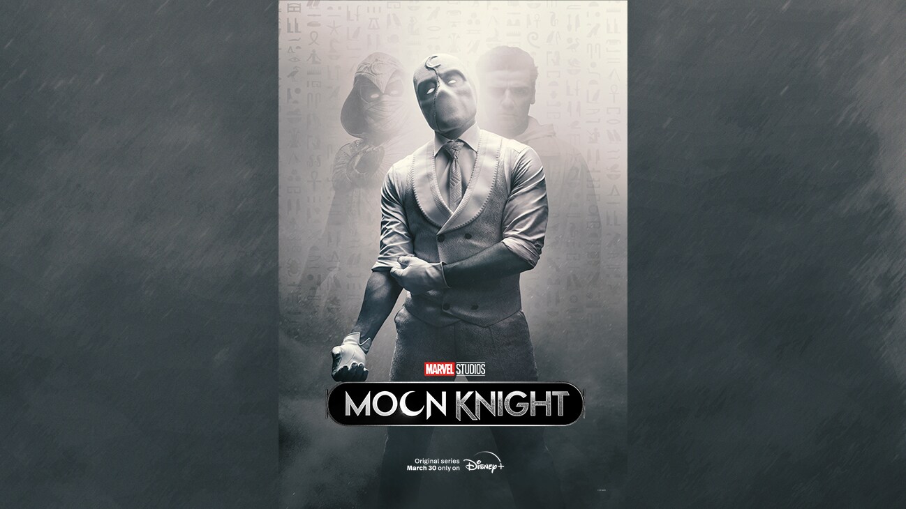 Image of Mr. Knight pulling up his right sleeve with images of a hooded character and Steven Grant (actor Oscar Issac) barely visible in the background from the Marvel Studios series "Moon Knight". Original series March 30 only on Disney+.