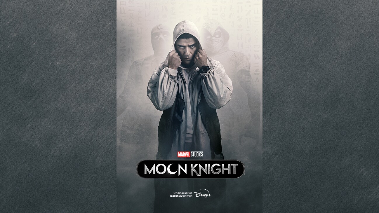 Image of Steven Grant (actor Oscar Issac) with his hands on his hood with two hooded characters barely visible in the background from the Marvel Studios series "Moon Knight". Original series March 30 only on Disney+.