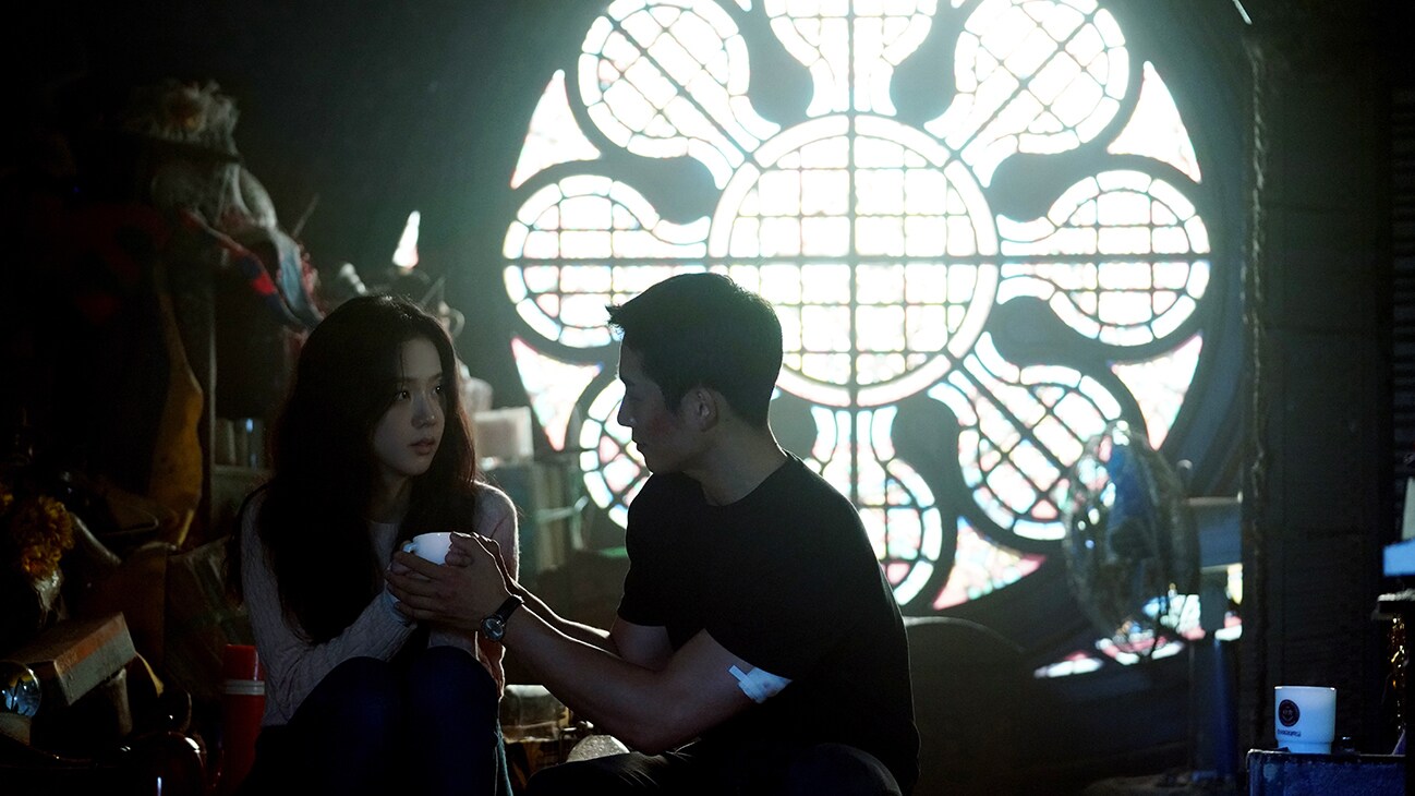 Im Soo Ho (Jung Hae-In) and Eun Yeong-ro (Jisoo) sit together in Snowdrop, exclusively on Disney+.