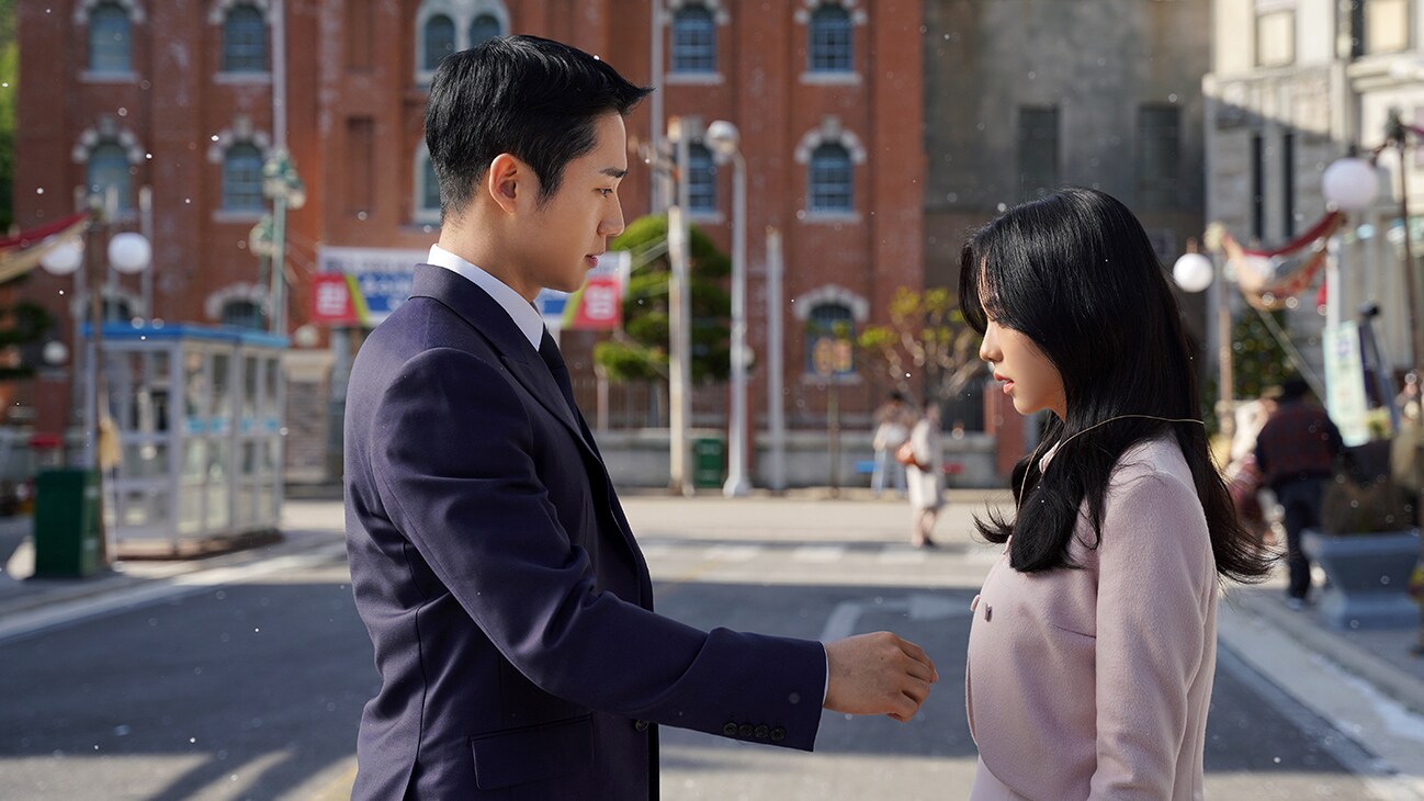 Im Soo Ho (Jung Hae-In) and Eun Yeong-ro (Jisoo) stand in the streets in Snowdrop, exclusively on Disney+.