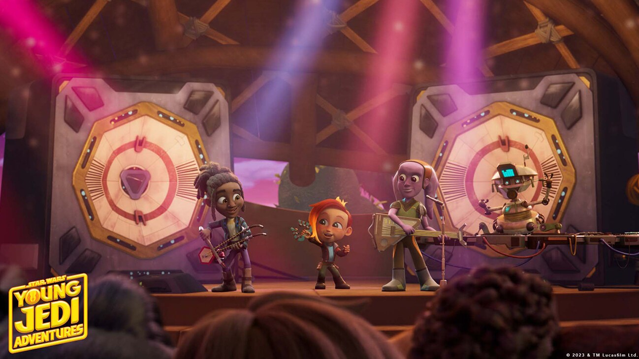 Nash Durango (voiced by Emma Berman), a droid, and several characters on stage playing instruments in a scene from "STAR WARS: YOUNG JEDI ADVENTURES", exclusively on Disney+ and Disney Junior. © 2023 Lucasfilm Ltd. & ™. All Rights Reserved.