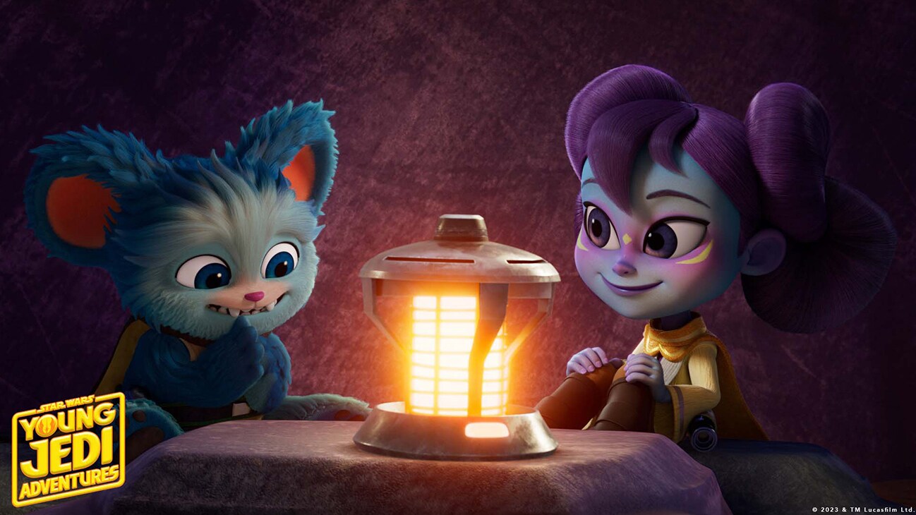 Nubs and Lys Solay sitting at a table with a lantern from "STAR WARS: YOUNG JEDI ADVENTURES", exclusively on Disney+ and Disney Junior. © 2023 Lucasfilm Ltd. & ™. All Rights Reserved.