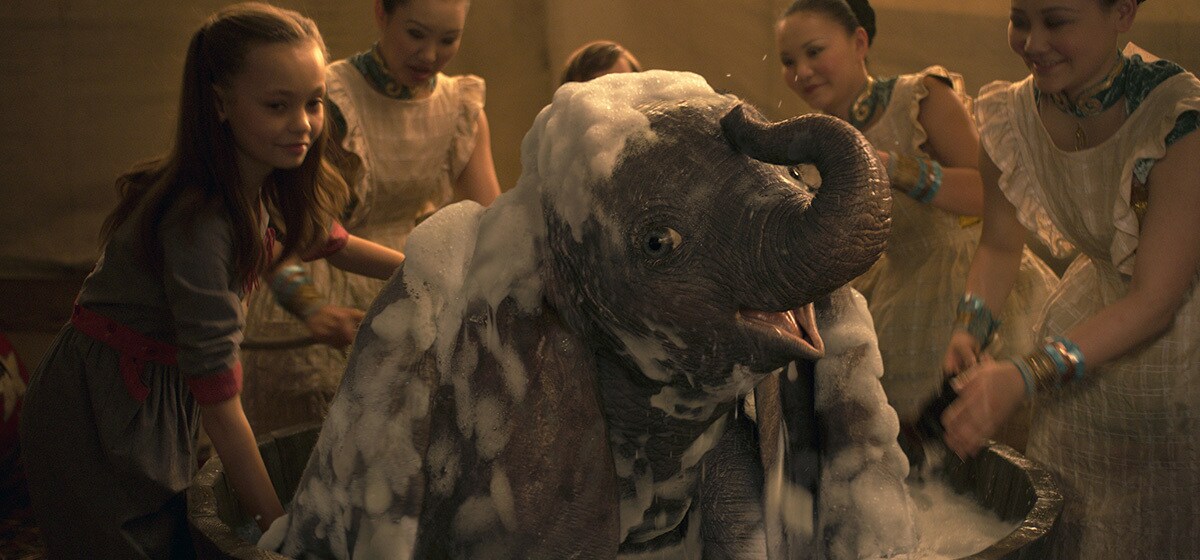 Nico Parker (Milly Farrier) gives Dumbo a bath from the movie "Dumbo"