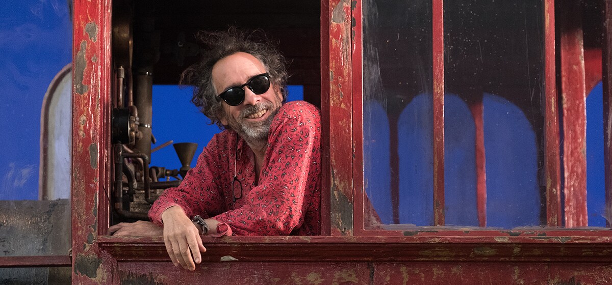 Tim Burton in the cabin of the train engine from the movie "Dumbo"