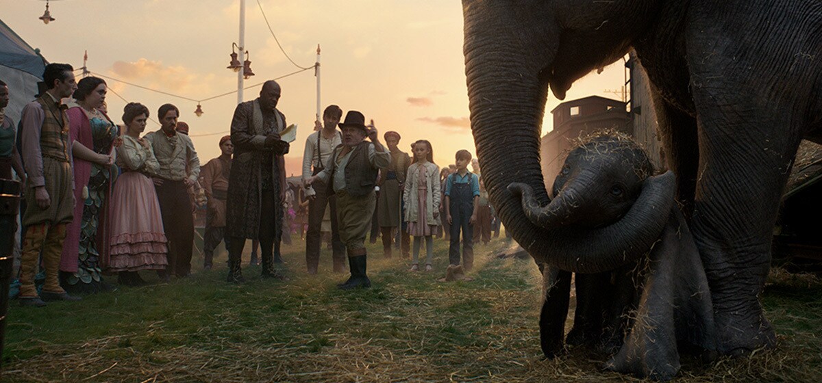 Max Medici (Danny DeVito) and the rest of the circus team welcomes the newborn elephant from the movie "Dumbo".