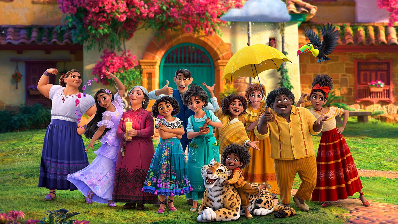 Image of a Mirabel and her extended family posing in front of a house from the Disney movie Encanto.