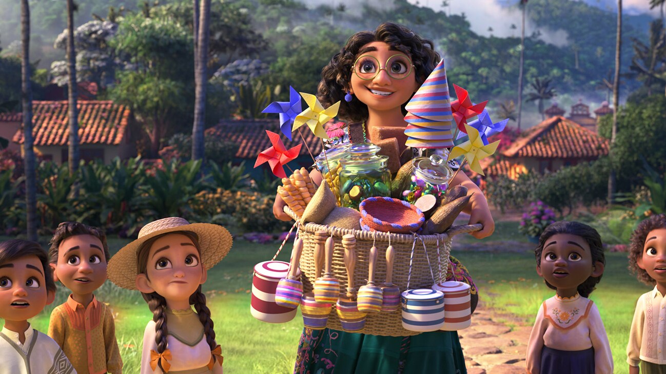 Image of Mirabel holding a basket of party hats, pinwheels, and other objects, surrounded by several children from the Disney movie Encanto.