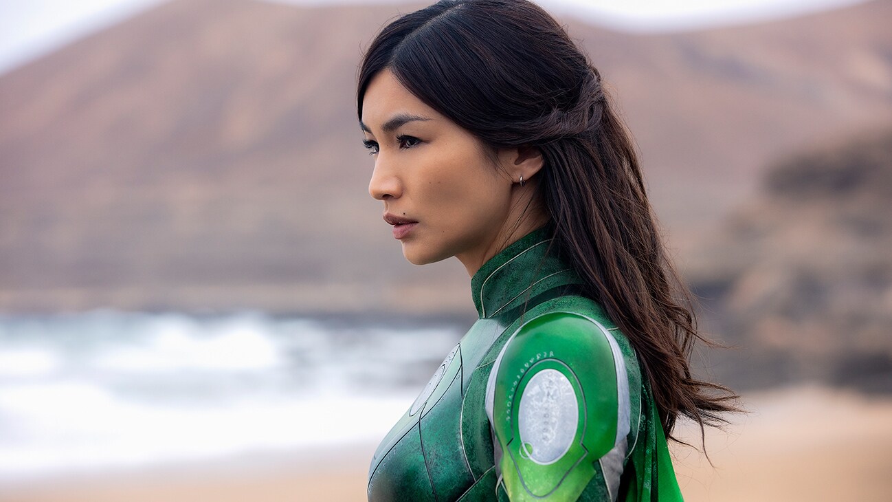 Sersi (actor Gemma Chan) standing on a beach from the Marvel Studios movie Eternals.