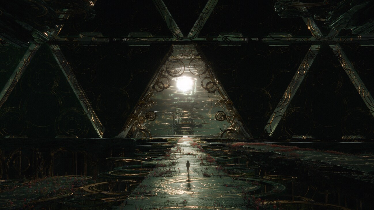 Image of a person walking along a dark and immense open walkway that faces a triangular opening with a bright spherical object in the distance from the Marvel Studios movie Eternals.