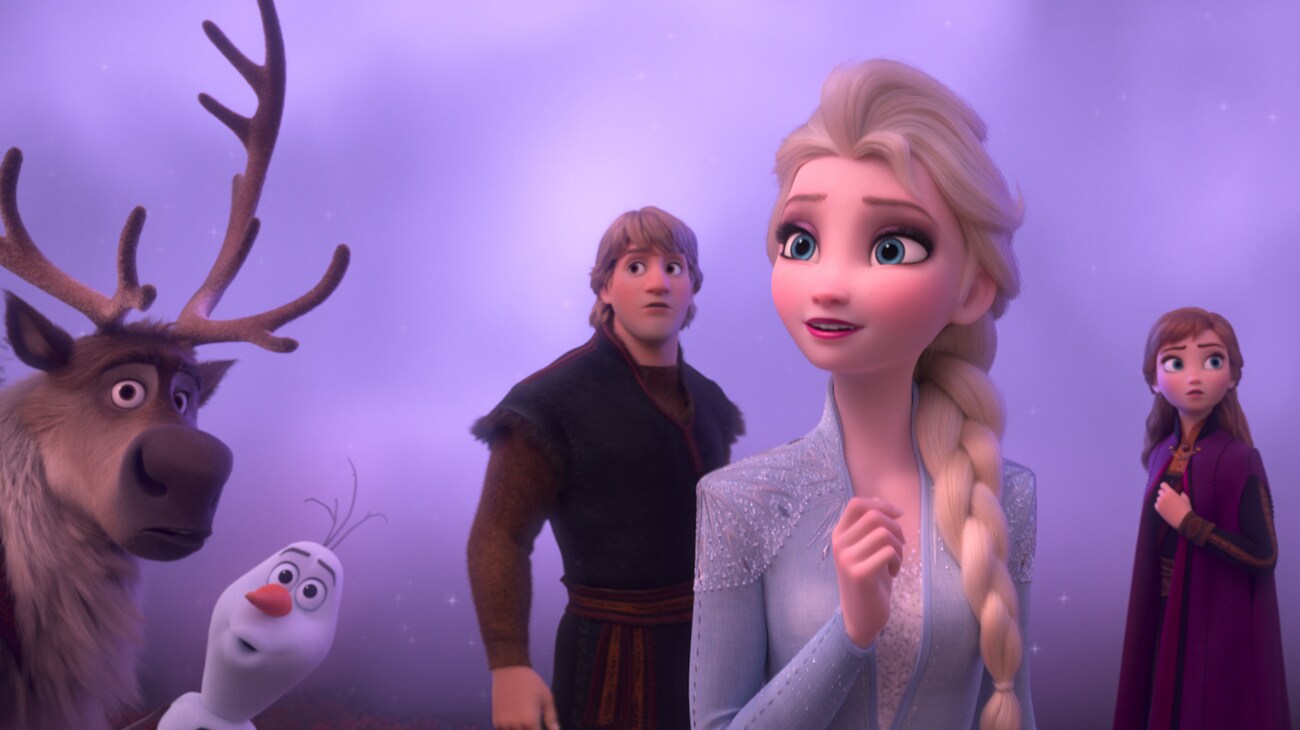 Elsa (voiced by Idina Menzel), Anna (voiced by Kristen Bell), Kristoff (voiced by Johnathan Groff), Olaf (voiced by Josh Gad), and Sven look in the distance in the movie Frozen 2.