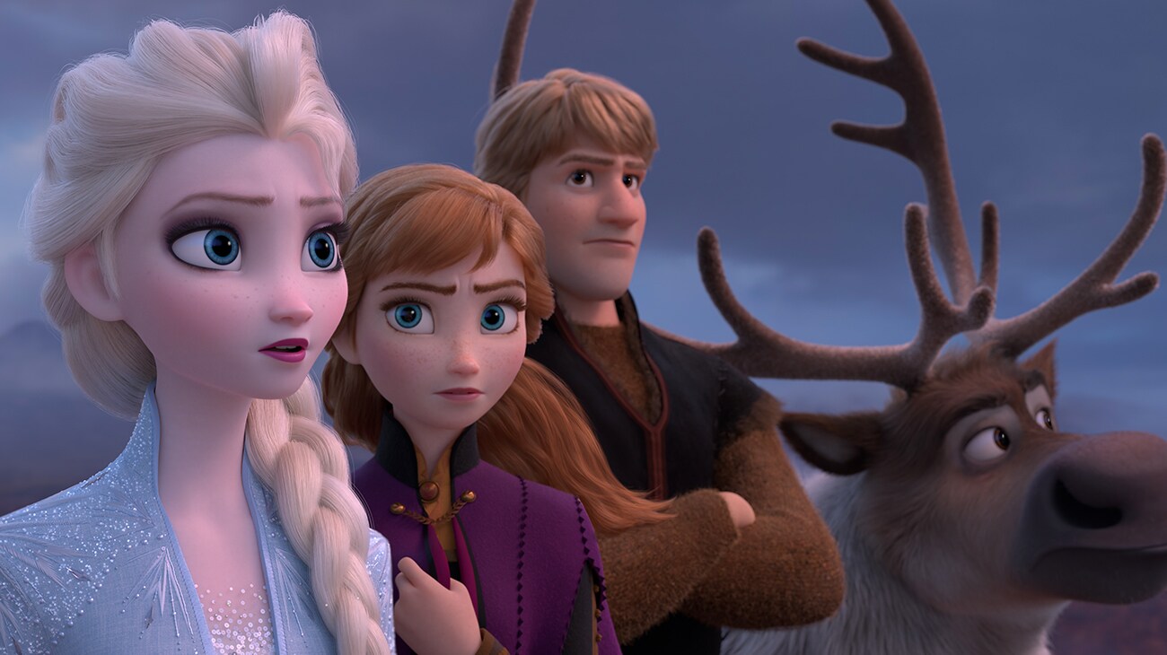 Elsa (voiced by Idina Menzel), Anna (voiced by Kristen Bell), Kristoff (voiced by Johnathan Groff), and Sven looking off into the distance in Frozen 2