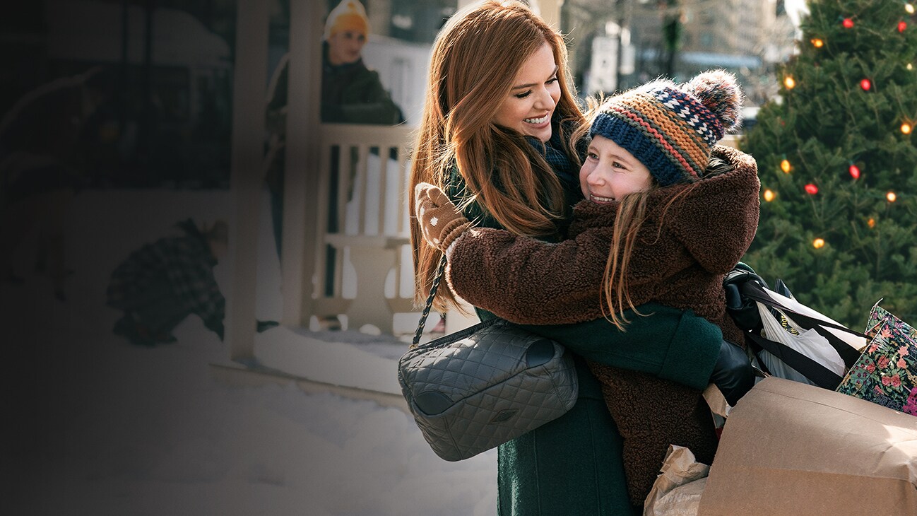 Isla Fisher as Mackenzie and Willa Skye as Mia in GODMOTHERED, exclusively on Disney+.