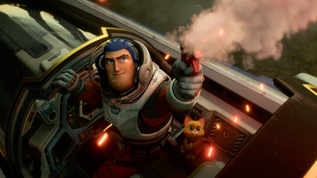 Image of Buzz Lightyear (voiced by actor Chris Evans) shooting a weapon from his cockpit alongside Sox (voiced by actor Peter Sohn) from the Disney•Pixar movie, "Lightyear".