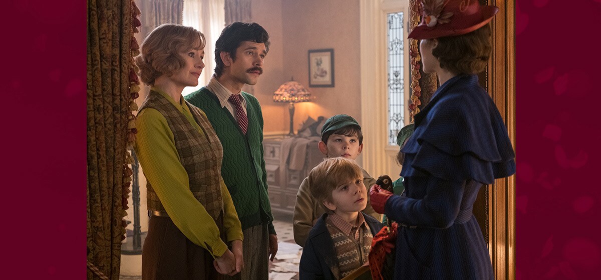 The Banks family standing in a doorway with Mary Poppins in "Mary Poppins Returns"