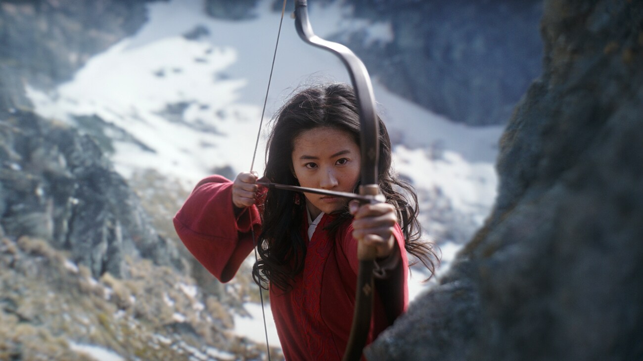 Yifei Liu (Mulan) with a bow and arrow in "Mulan"