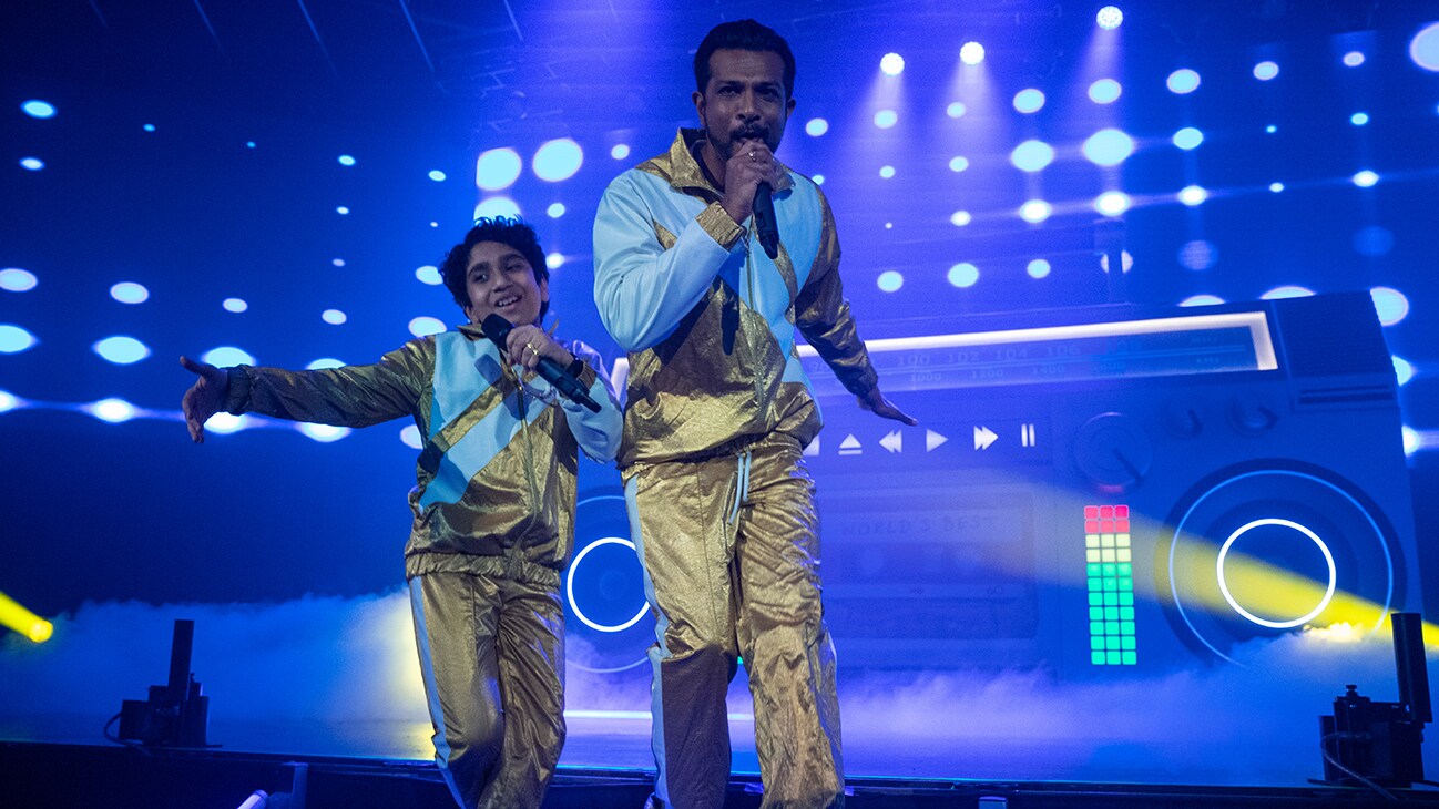 (L-R): Manny Magnus as Prem and Utkarsh Ambudkar as Suresh in WORLD'S BEST, exclusively on Disney+. Photo by Ben Mark Holzberg. © 2023 Disney Enterprises, Inc. All Rights Reserved.	
