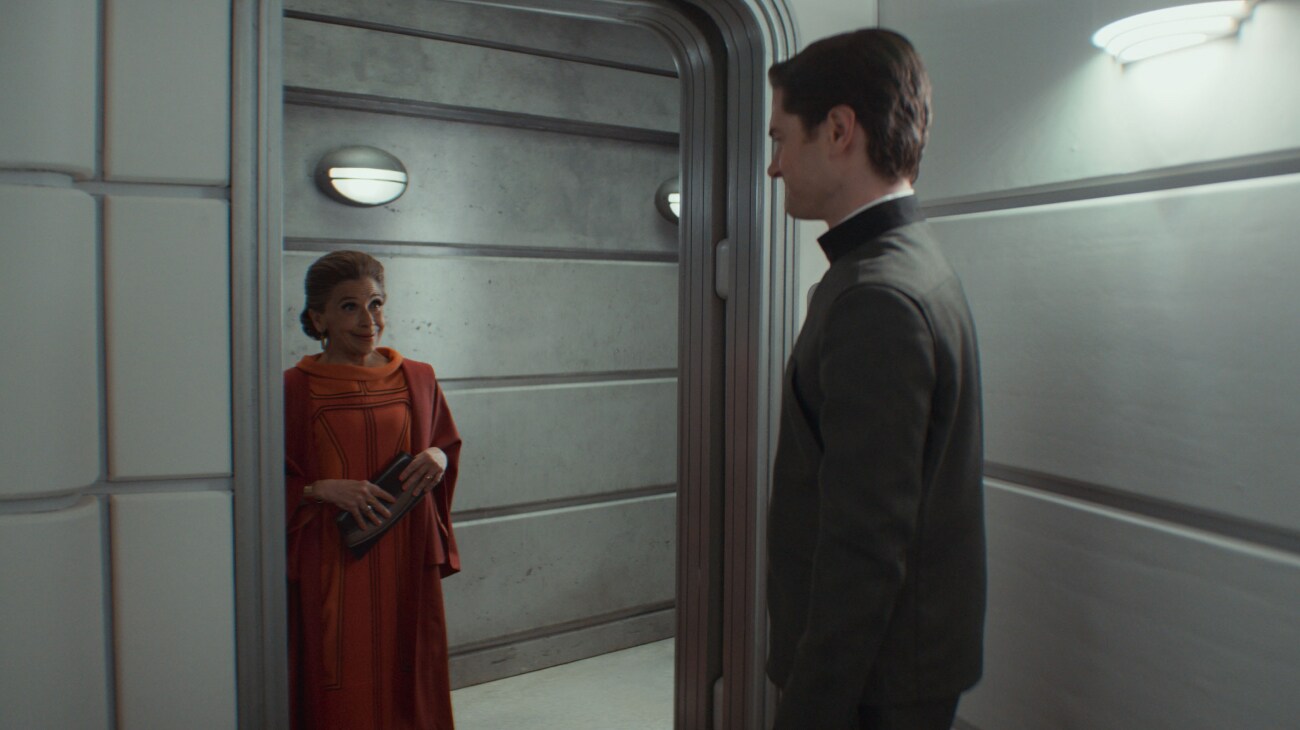 (L-R) Eedy Karn (Kathryn Hunter) and Syril Karn (Kyle Soller) in Lucasfilm's ANDOR Season 2, exclusively on Disney+. Photo courtesy of Lucasfilm. ©2025 Lucasfilm Ltd. & TM. All Rights Reserved.