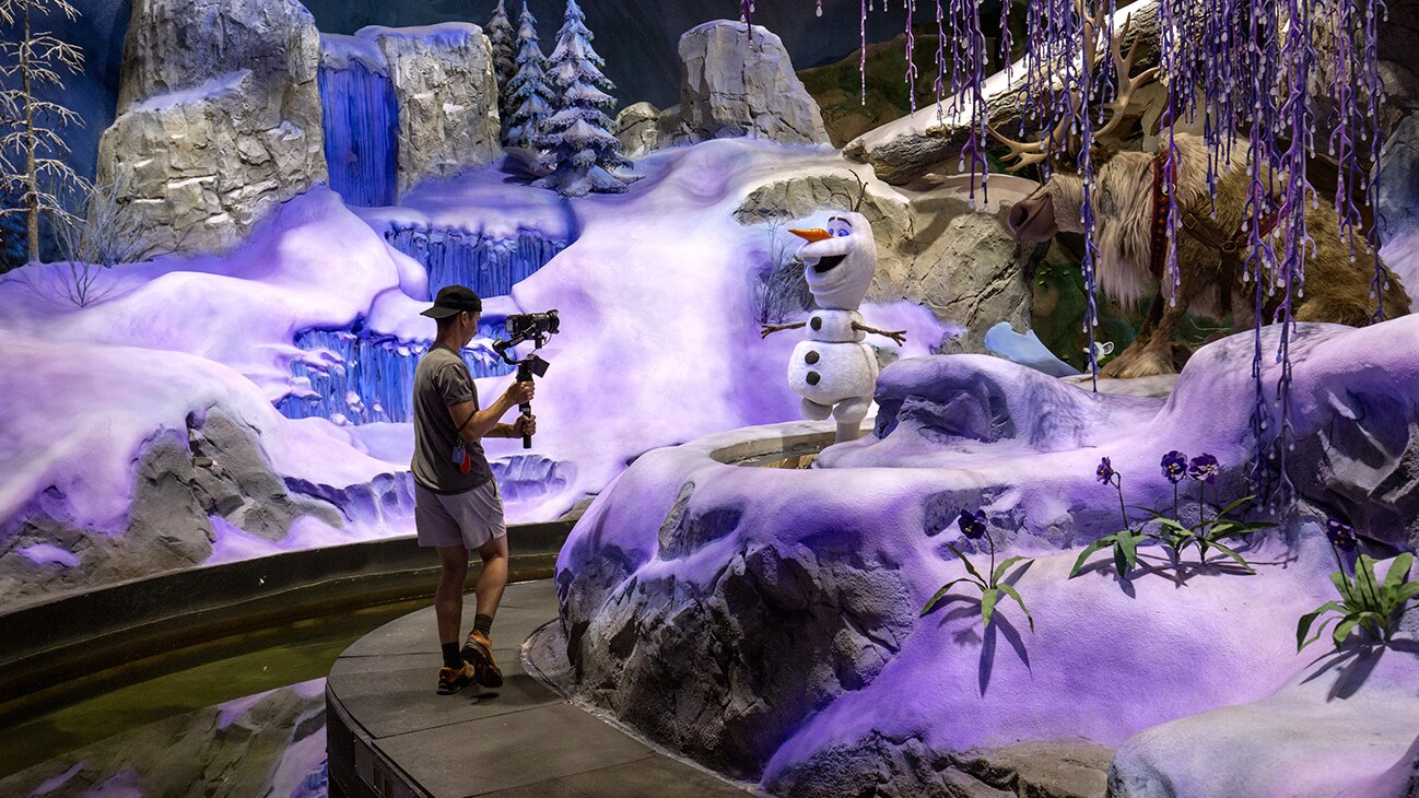 Image of a crew member filming Olaf at EPCOT.