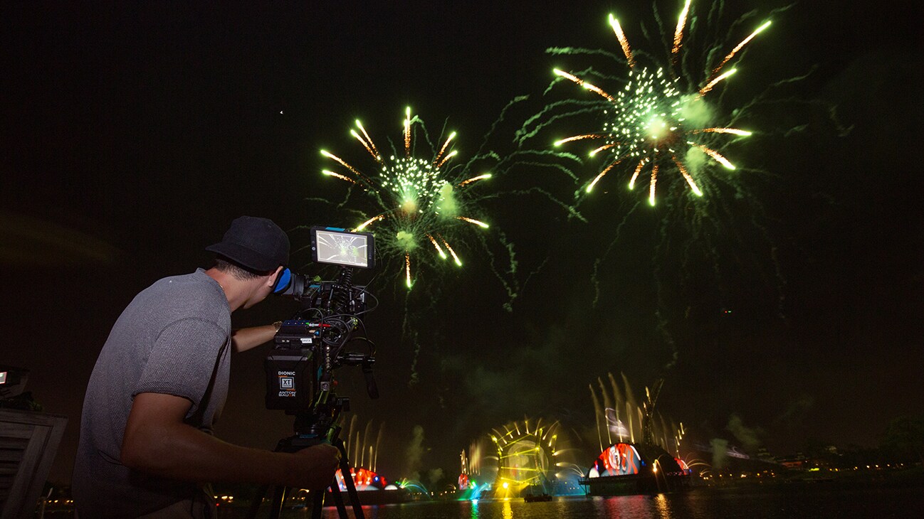 Image of a camera man shooting the fireworks display.