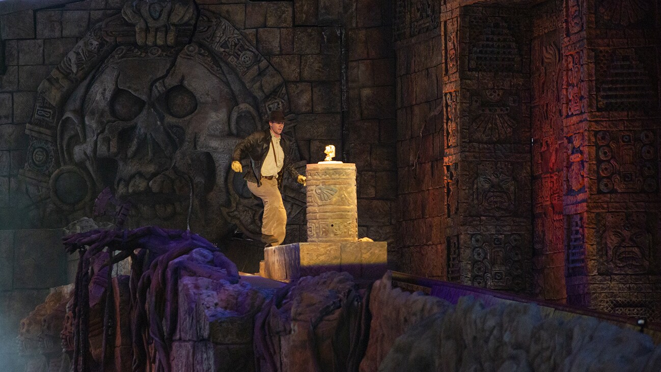 Image of Indiana Jones in front of the golden statue from the Indiana Jones Adventure ride.