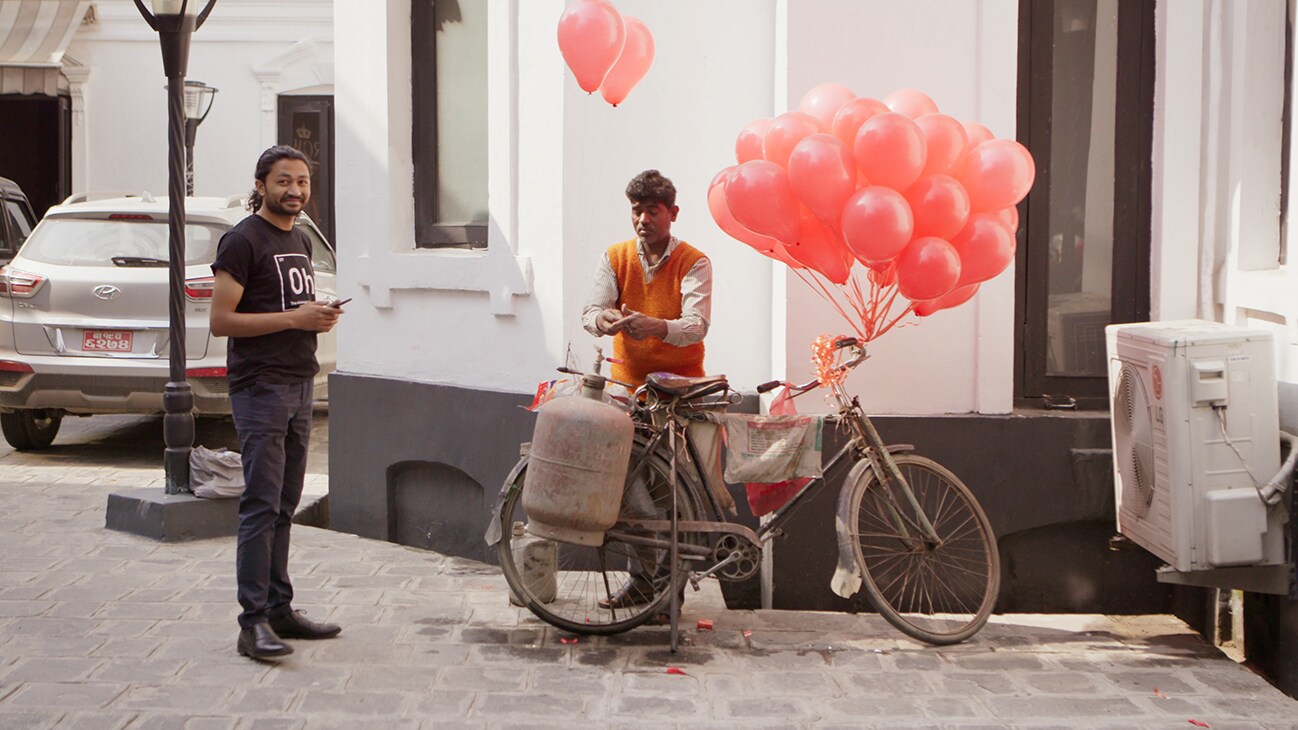 Bhaktapur, Nepal - Santosh Pandey, Co-Founder of Offering Happiness, waits for balloons to be inflated in Bhaktapur, Nepal. (Credit: Future of Work Film Inc)