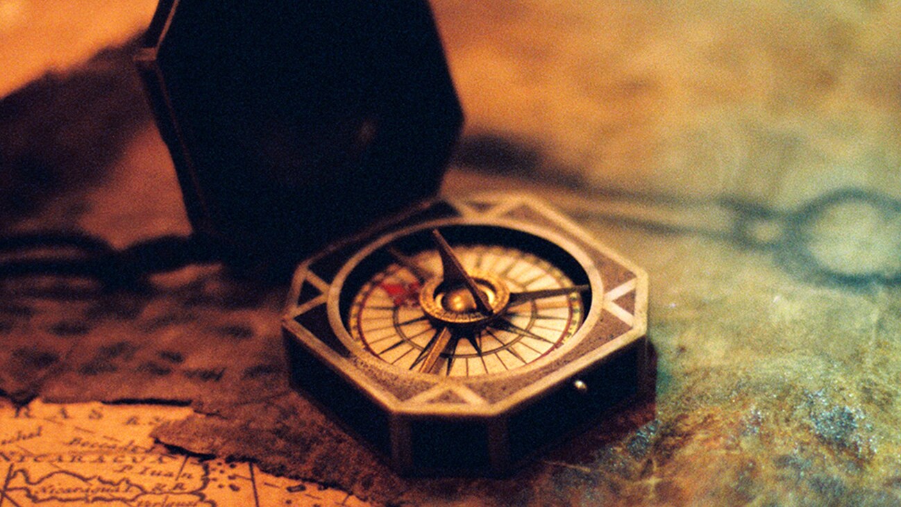 Image of a compass sitting on a map in the Disney movie Pirates of the Caribbean: Dead Man's Chest.