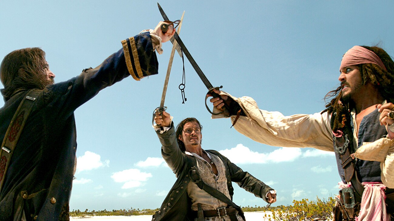 Jack Sparrow (Johnny Depp), Will Turner (Orlando Bloom), and Norrington (Jack Davenport) in the Disney movie Pirates of the Caribbean: Dead Man's Chest.