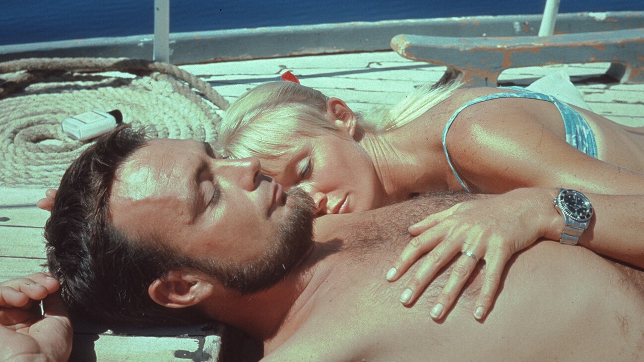 Valerie & Ron Taylor sunbathing together on a boat deck in 1967. (photo credit: Ron & Valerie Taylor)