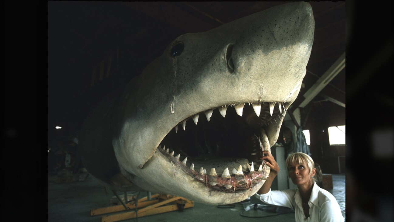 Valerie Taylor on the Jaws film set standing next to a shark prop in 1974. (photo credit: Ron & Valerie Taylor)