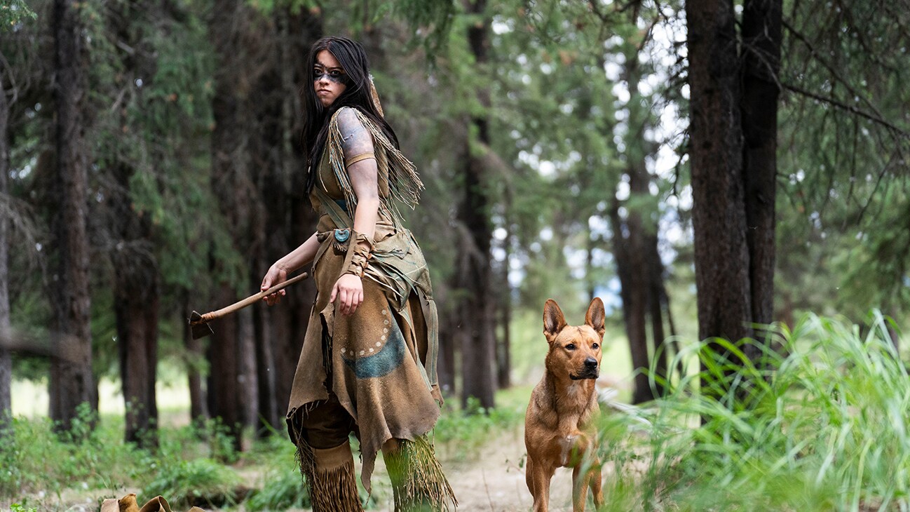 Image of a Native American and a dog from the Hulu original movie, "Prey".