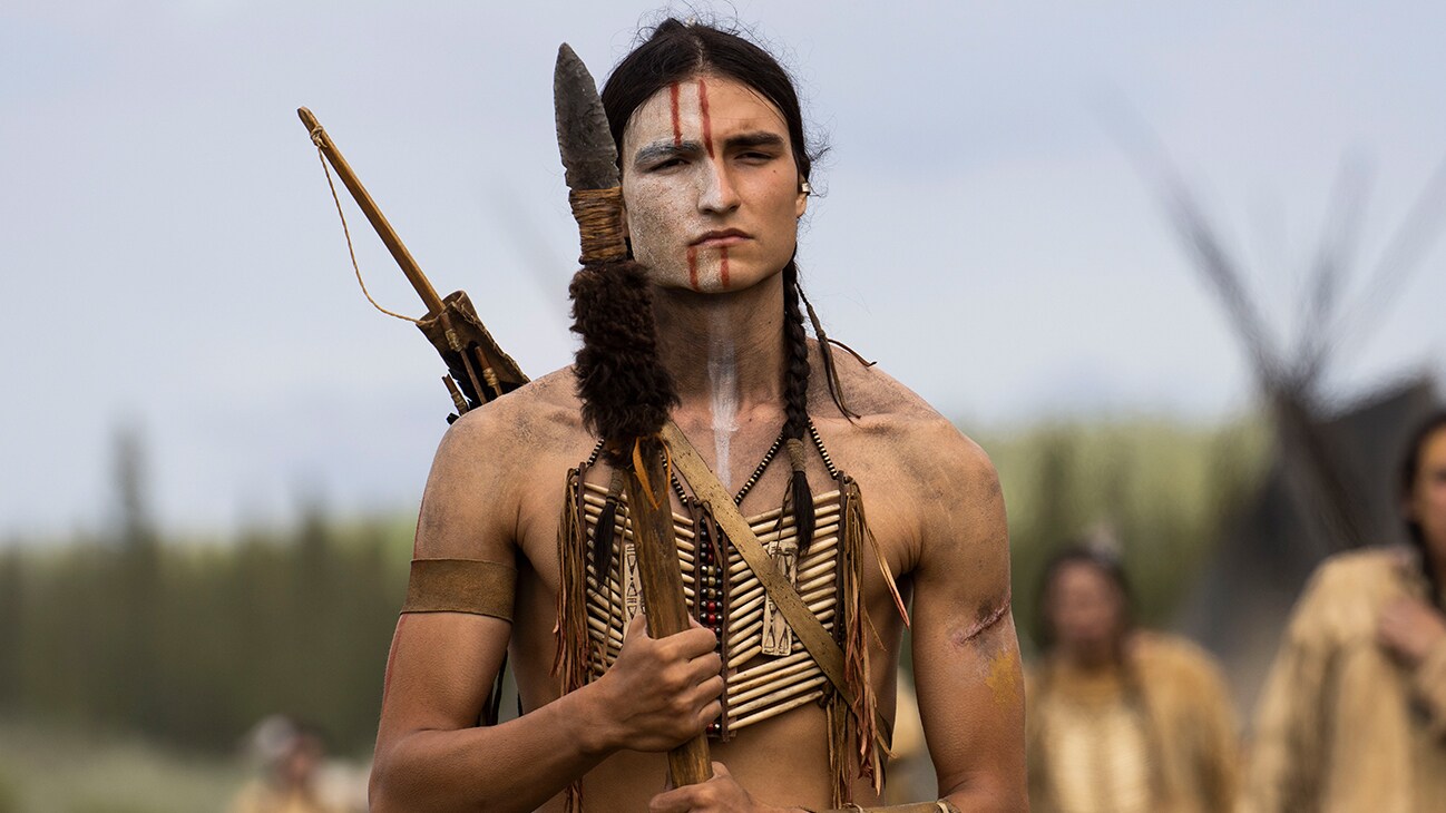 Taabe (actor Dakota Beavers) holding a spear from the Hulu original movie, "Prey".