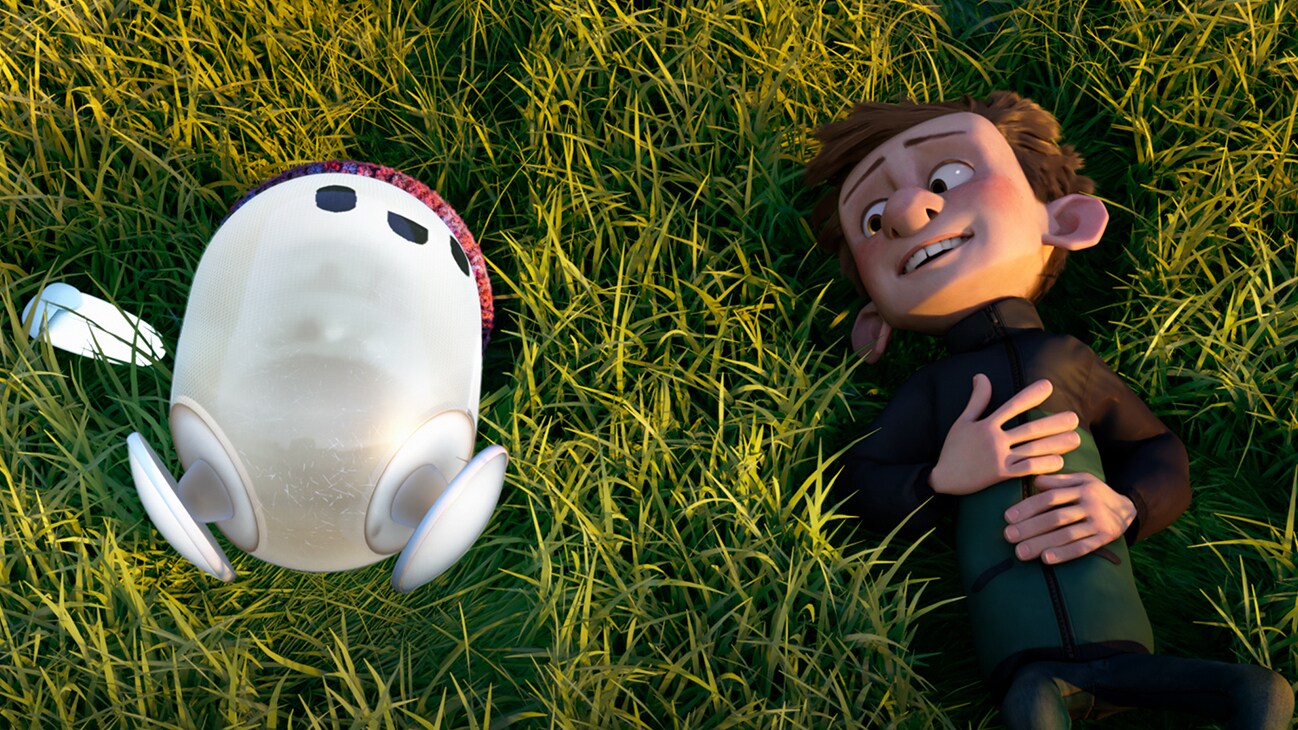 Image of Ron and Barney lying on the grass from the 20th Century Studios movie Ron's Gone Wrong.