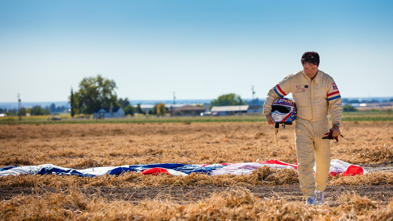 Image of Eddie Braun walking away from a parachute with his helmet in his hand from the Disney+ Originals movie Stuntman. (Disney/ Steve Dondero)