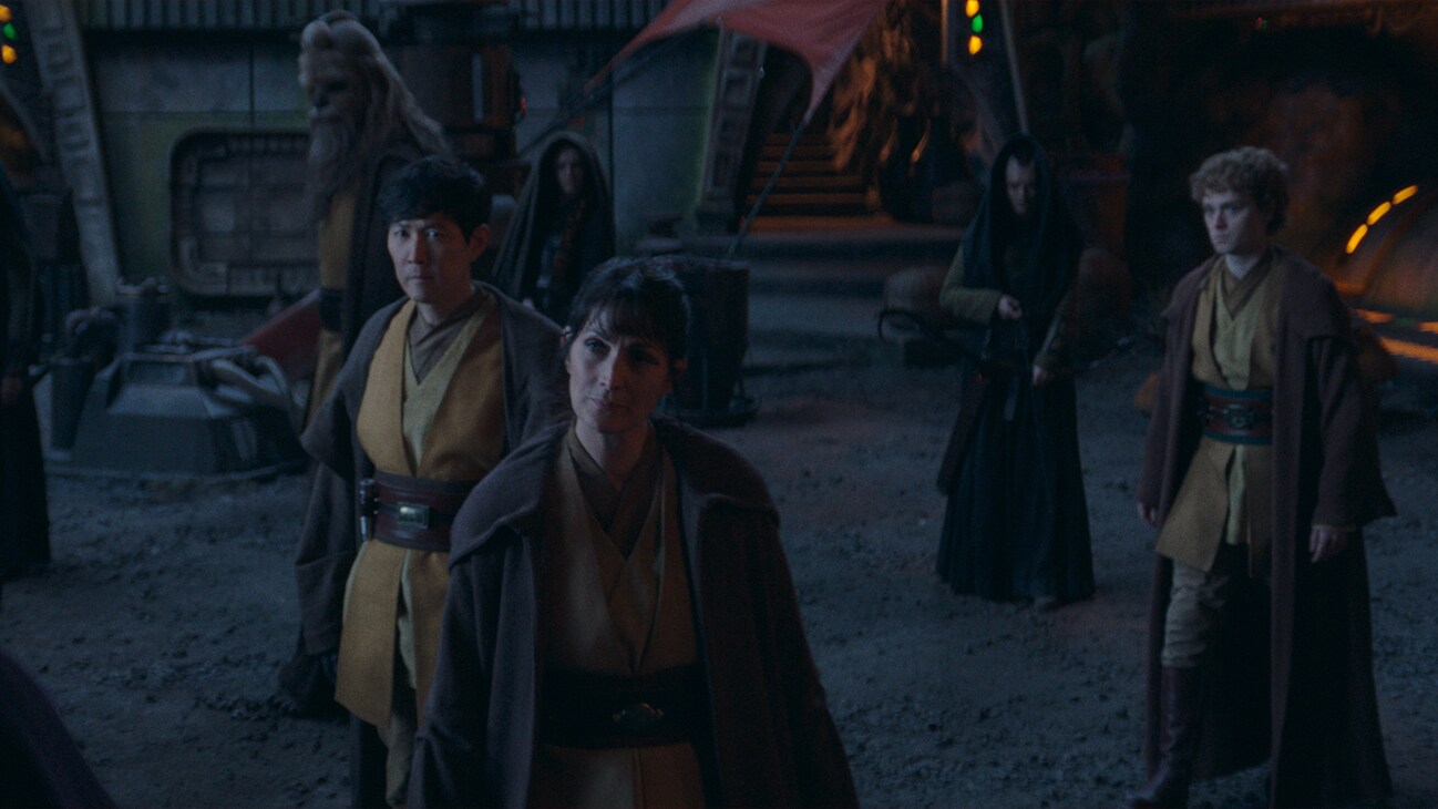 (Clockwise from center): Jedi Master Indara (Carrie-Anne Moss), Master Sol (Lee Jung-jae), Jedi Master Kelnacca (Joonas Suotamo) and (second from right) Master Torbin (Dean Charles Chapman) in Lucasfilm's THE ACOLYTE, exclusively on Disney+. ©2024 Lucasfilm Ltd. & TM. All Rights Reserved.