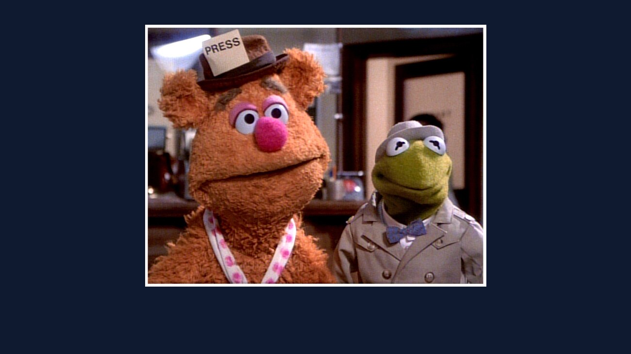 Fozzie and Kermit from the Disney movie The Great Muppet Caper.