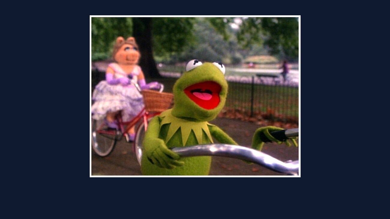 Kermit and Miss Piggy riding bicycles from the Disney movie The Great Muppet Caper.