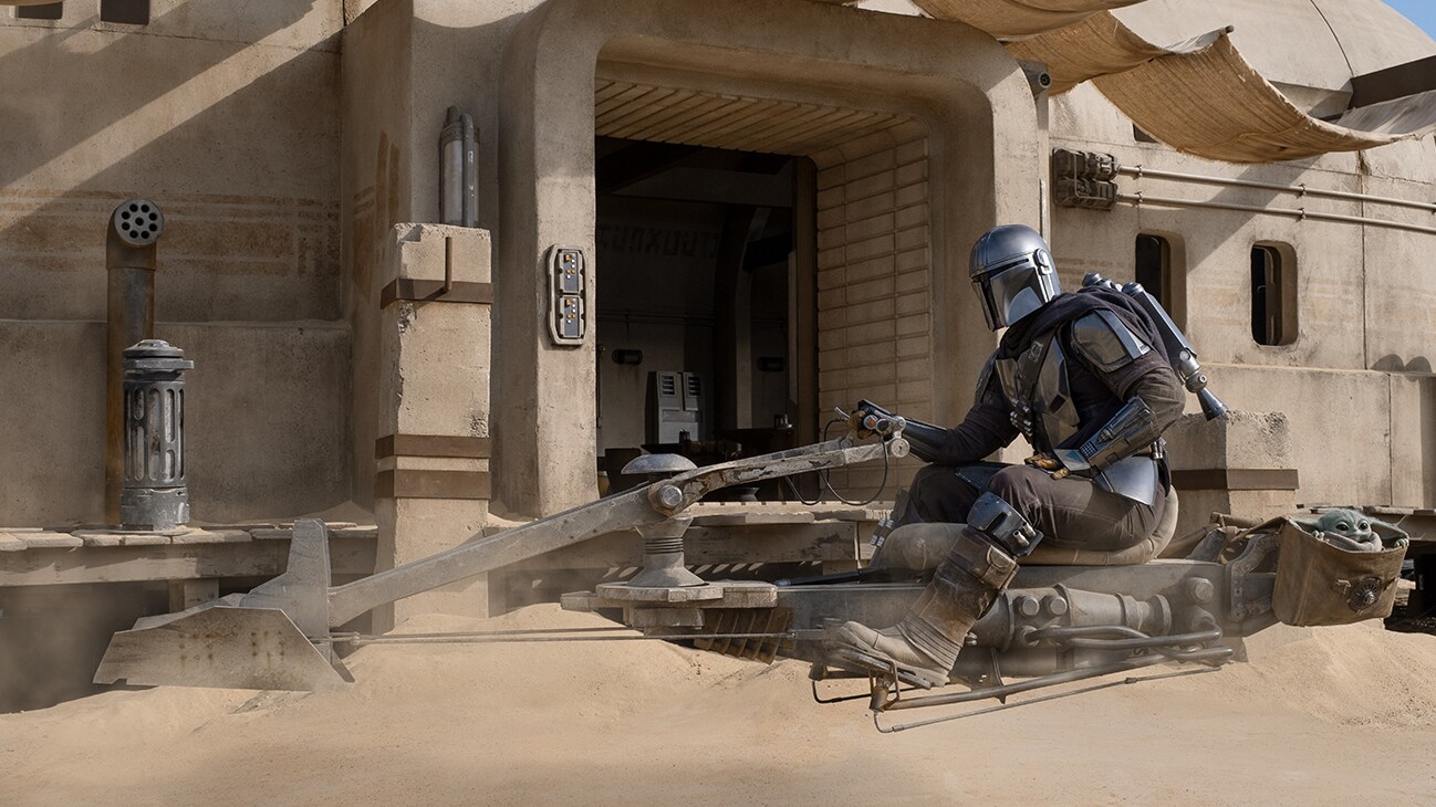 The Mandalorian (Pedro Pascal) and the Child in THE MANDALORIAN, season two, exclusively on Disney+