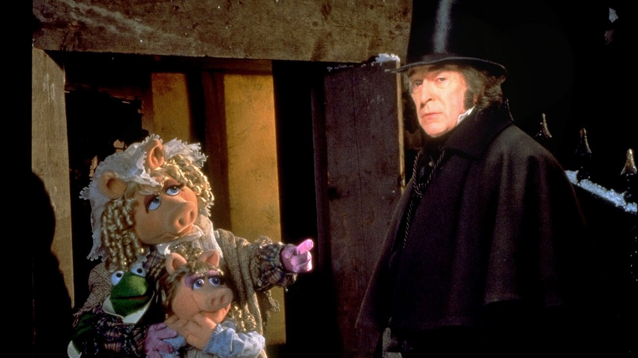 Ebenezer Scrooge (Michael Caine) and Miss Piggy as Emily Cratchit (voice of Frank Oz) from the Disney movie The Muppet Christmas Carol.