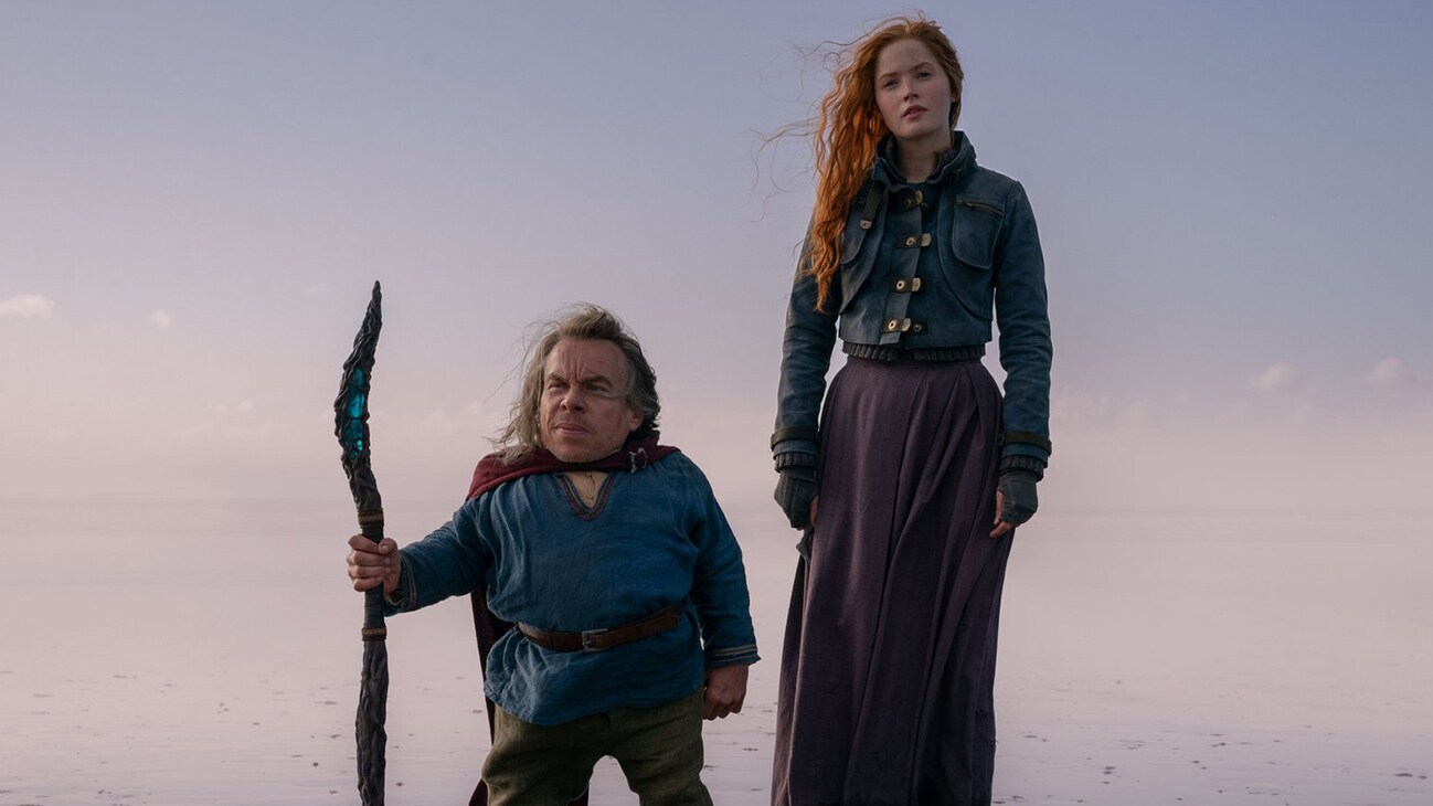 Willow Ufgood (Warwick Davis) and Elora (Ellie Bamber) in Lucasfilm's WILLOW exclusively on Disney+. ©2022 Lucasfilm Ltd. & TM. All Rights Reserved.