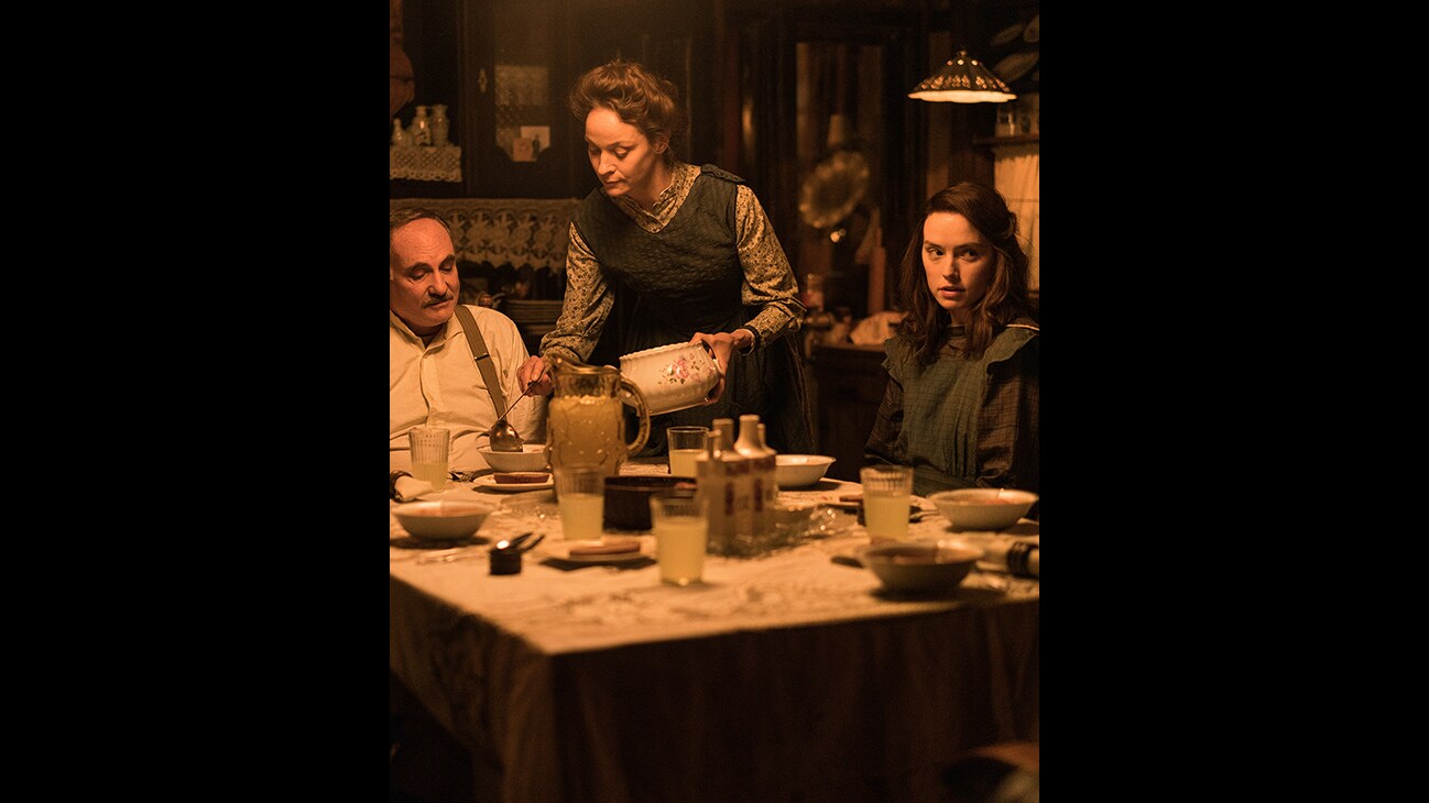 (L-R): Kim Bodnia as Henry Ederle, Jeanette Hain as Gertrud Ederle, Daisy Ridley as Trudy Ederle in Disney's live-action YOUNG WOMAN AND THE SEA. Photo by Elena Nenkova. © 2024 Disney Enterprises, Inc. All Rights Reserved.
