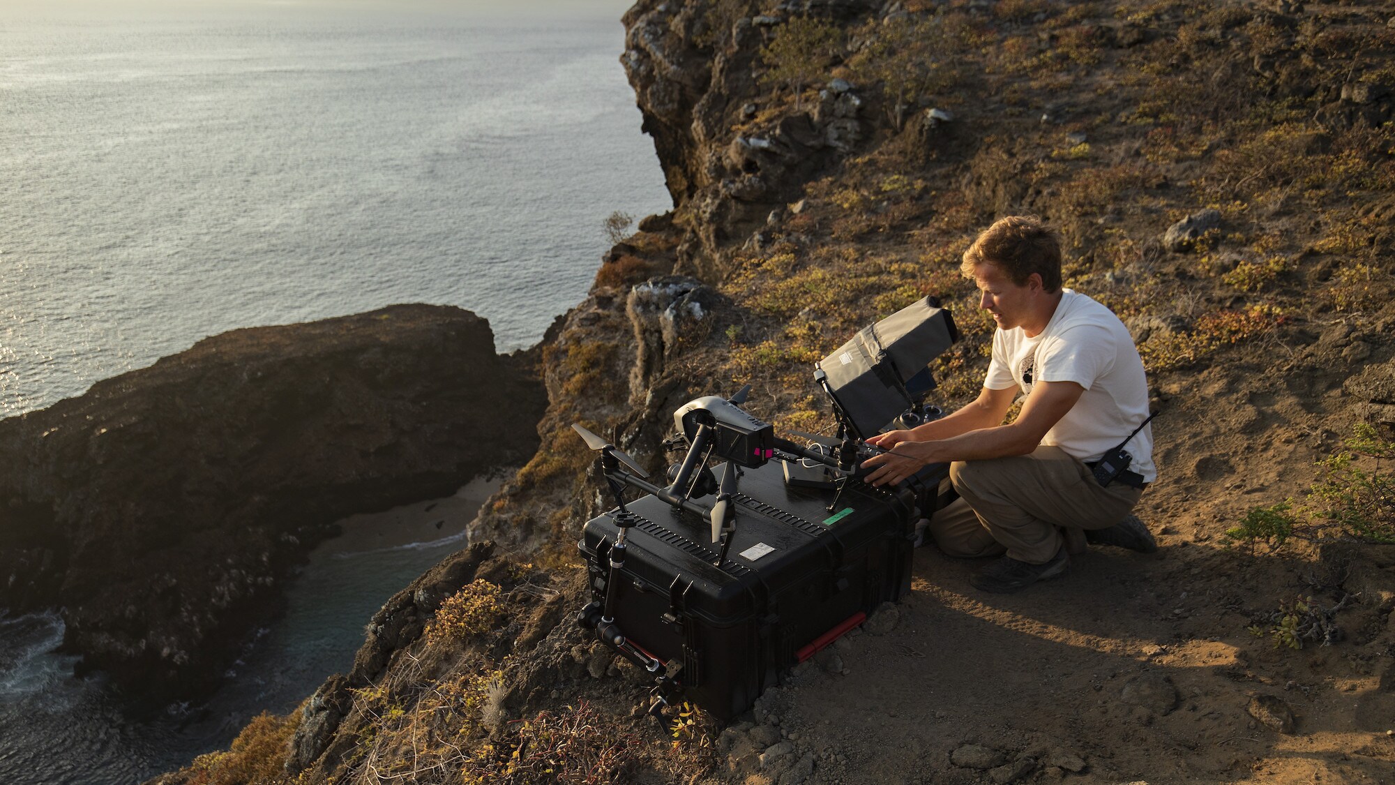 Bertie Gregory sits on the rocks as he views drone footage. (National Geographic for Disney+/Rakel Hansen)
