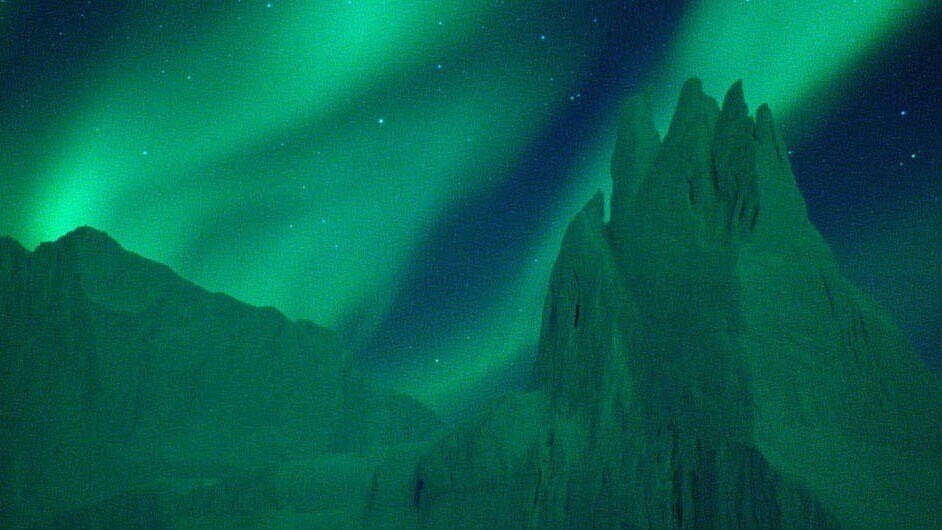 Glowing Green aurora borealis in the night sky 