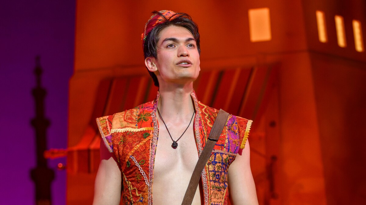 A closeup of Aladdin singing in Agrabah