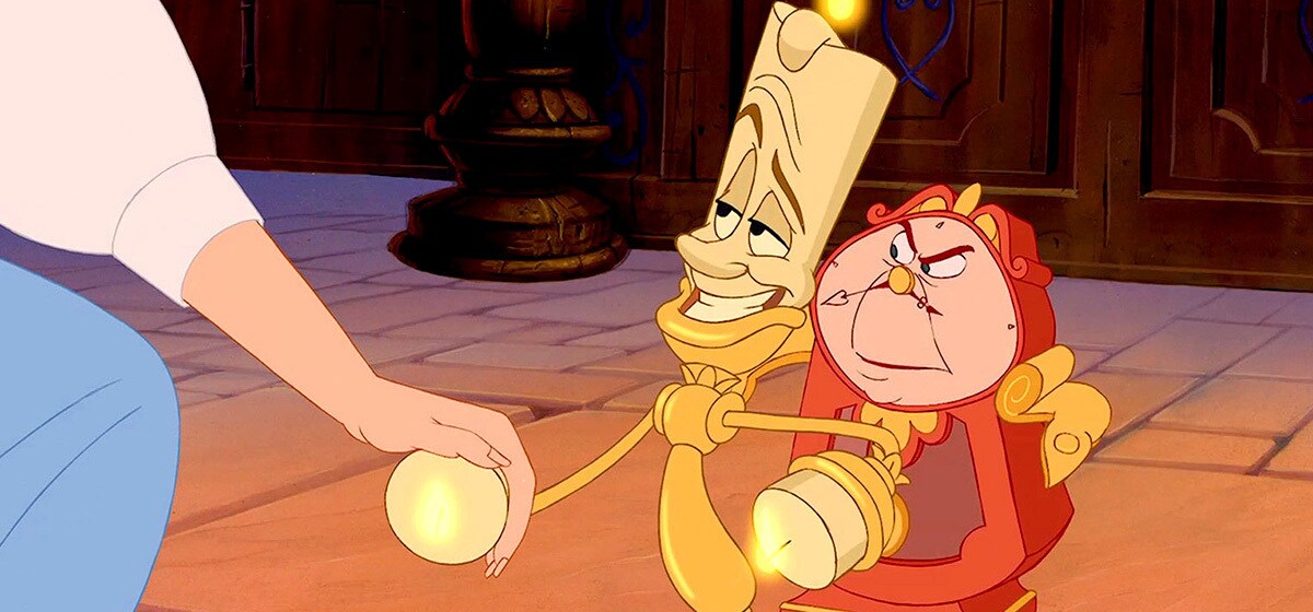 Paige O'Hara as Belle, Jerry Orbach as Lumiere, and David Ogden Stiers as Cogsworth/Narrator in the Disney movie Beauty and the Beast (1991).