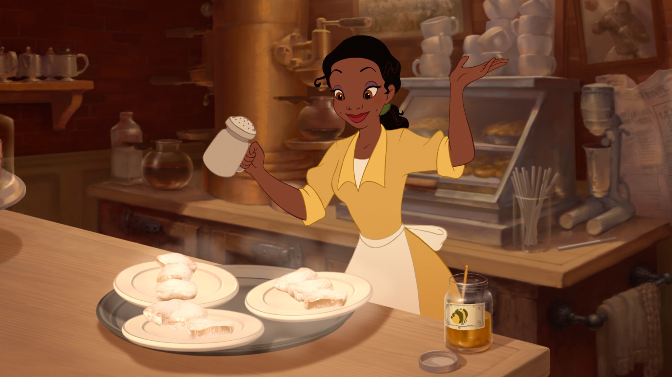 Disney Princess Tiana putting the final touches on her beignets. 