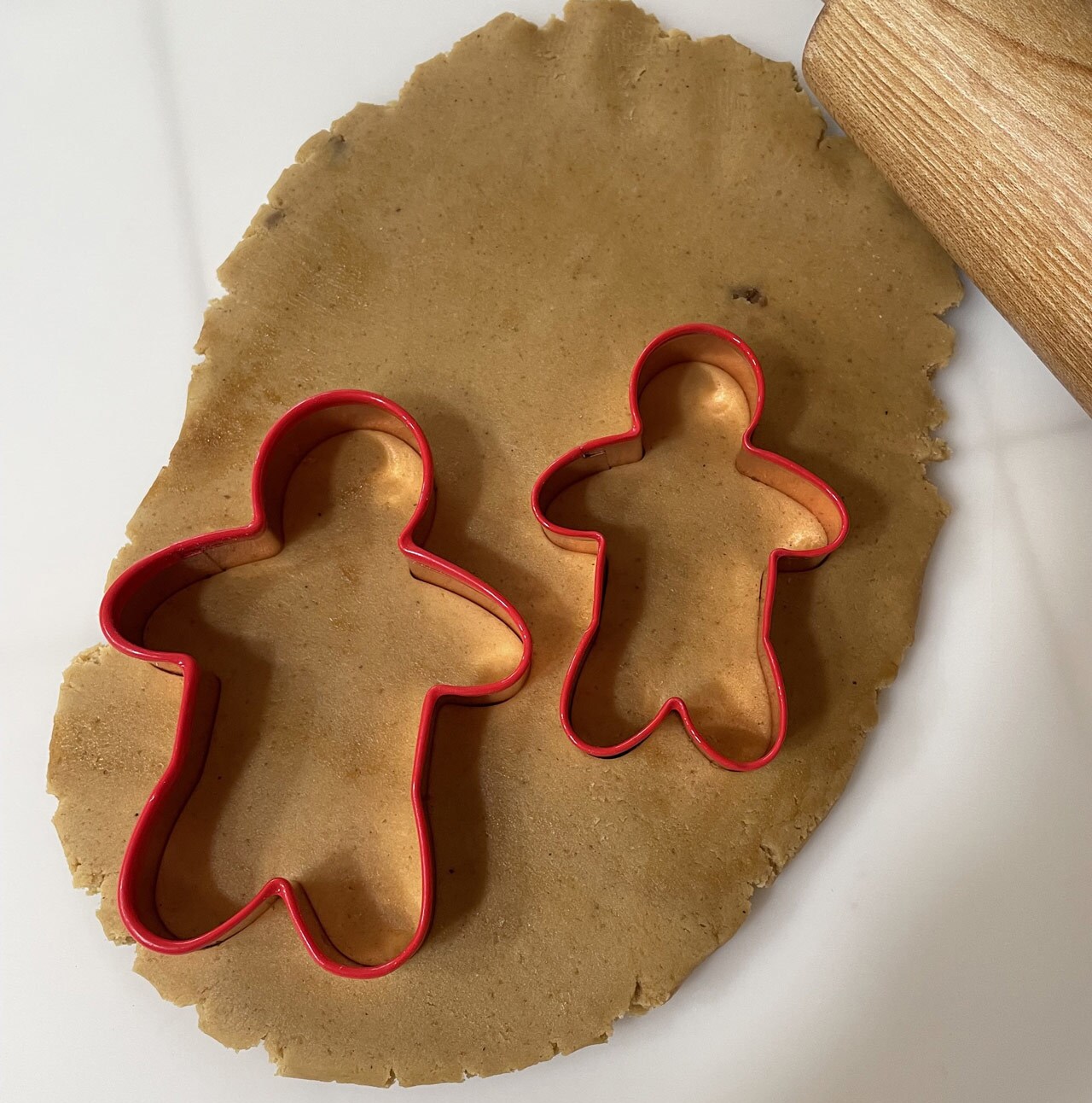 Gingrebread cut outs on dough.